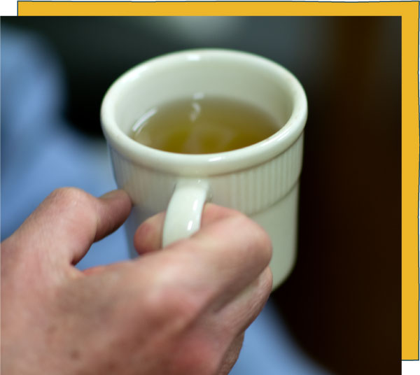 Hand holding a cup of tea